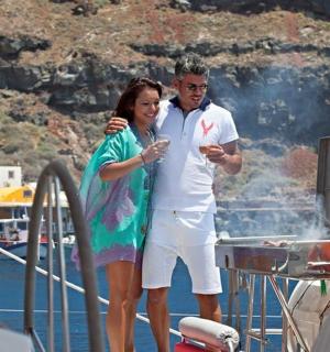 a man and a woman standing on a boat