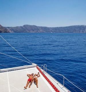 three people on a sail boat in the water