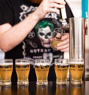 a group of glasses of beer on a bar