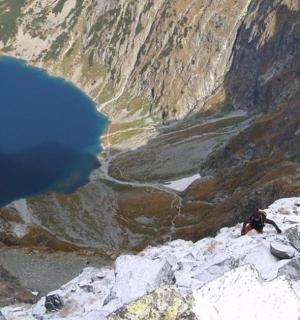 a blue lake on the side of a mountain