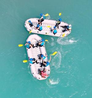 two boats with people on them in the water