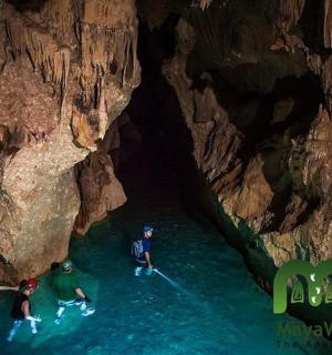 a group of people in the water in a cave