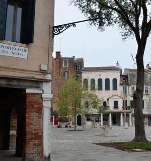 a man walking down a street next to a building