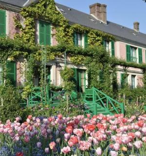 a large house with flowers in front of it