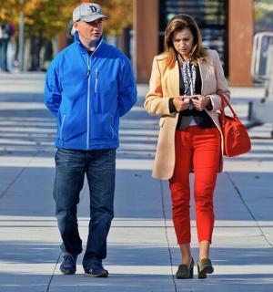 a man and a woman walking down a sidewalk