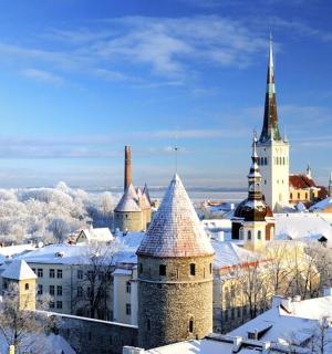 a city covered in snow with towers and buildings
