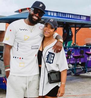 a man and a woman standing next to a cart