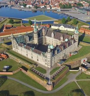an aerial view of a castle with a river