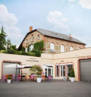 a building with tables and chairs in front of it