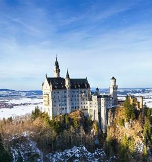 a castle on top of a mountain in the snow