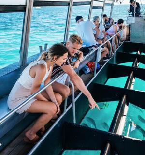 a man and woman sitting on a boat in the water