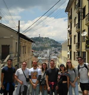 a group of people walking down a city street