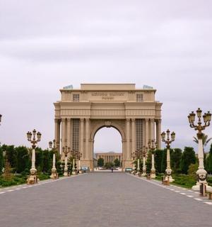 an arch in a park with a road