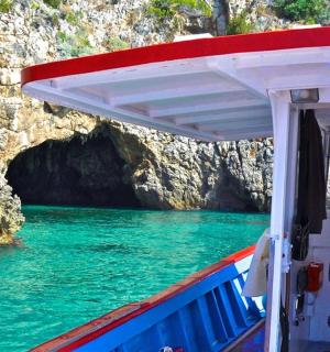 a boat in the water in front of a cave