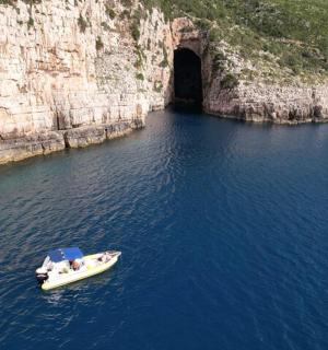 a boat in the water in front of a cave