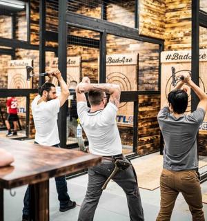 a group of men standing around a table with their arms up