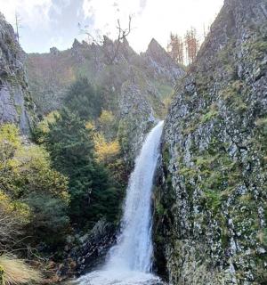 a waterfall on the side of a rocky mountain