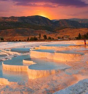 a group of ice formations in a river at sunset