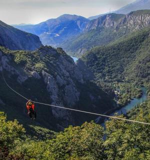 a person on a zip line in the mountains