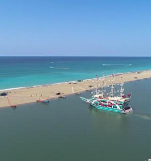 a boat in the water next to a beach