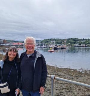 a man and woman standing next to a body of water