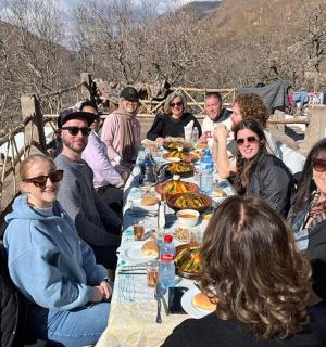 a group of people sitting around a long table