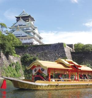 a boat in the water in front of a castle