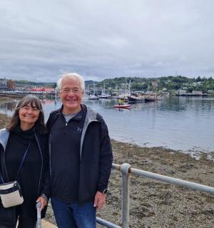 a man and woman standing next to a body of water