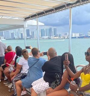 a group of people sitting on a boat in the water