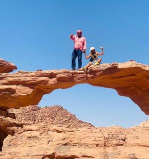 a man and a child standing on a rock formation