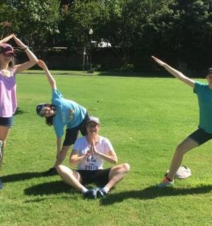 a group of people playing with a frisbee in a field