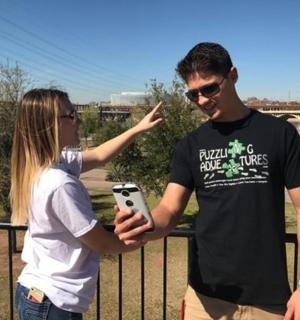 a man and a woman looking at a cell phone