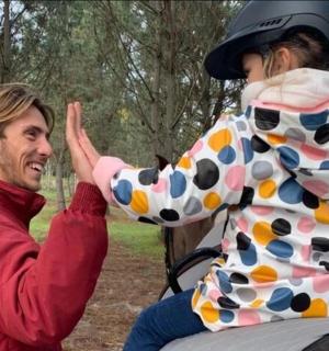 a man is giving a little girl a high five