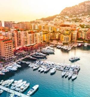 a group of boats docked in a harbor in a city