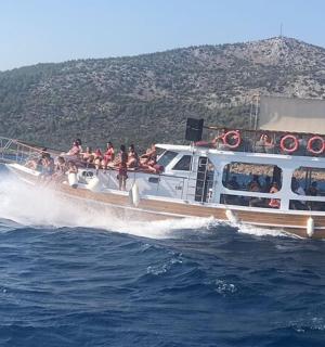 a boat full of people riding on the water