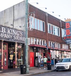 a small white car is parked on a city street