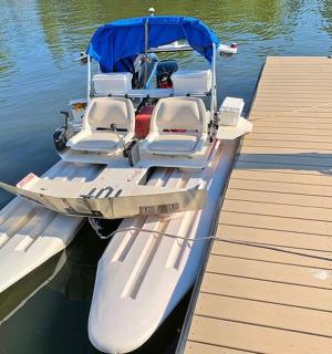 a boat docked next to a dock in the water