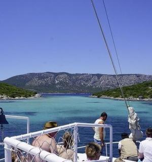 a group of people on a boat in the water
