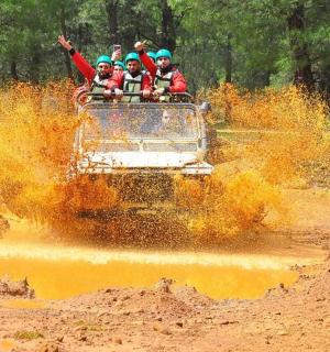 a group of people riding in the back of an off road vehicle