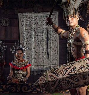 two women and a man standing on a beam in a room