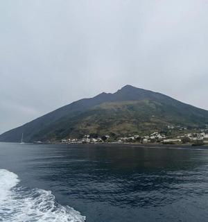 a mountain in the middle of a body of water