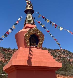 a pagoda with prayer flags on top of it