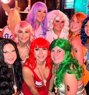 a group of women dressed up in costumes at a party
