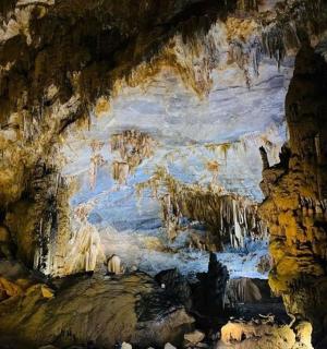 a painting of a cave with ice formations