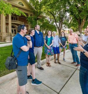 a group of people standing outside of a house