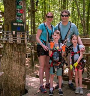eine Familie posiert für ein Foto im Wald