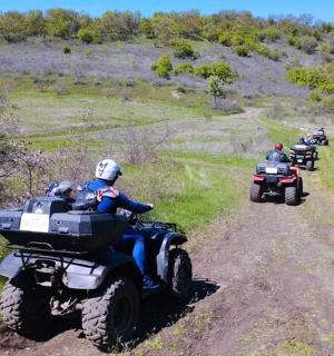 a group of people riding on atvs on a dirt road