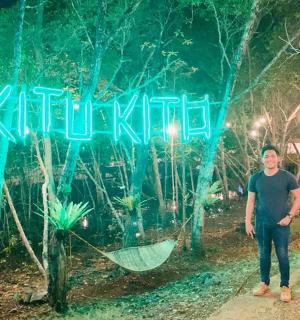 a man and a woman standing in front of a sign