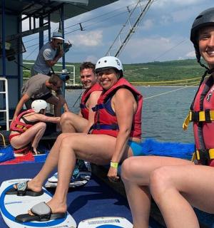 a group of people sitting on a boat in the water