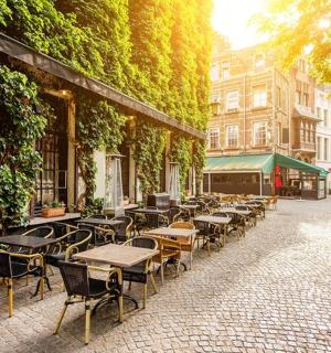 a group of tables and chairs on a street